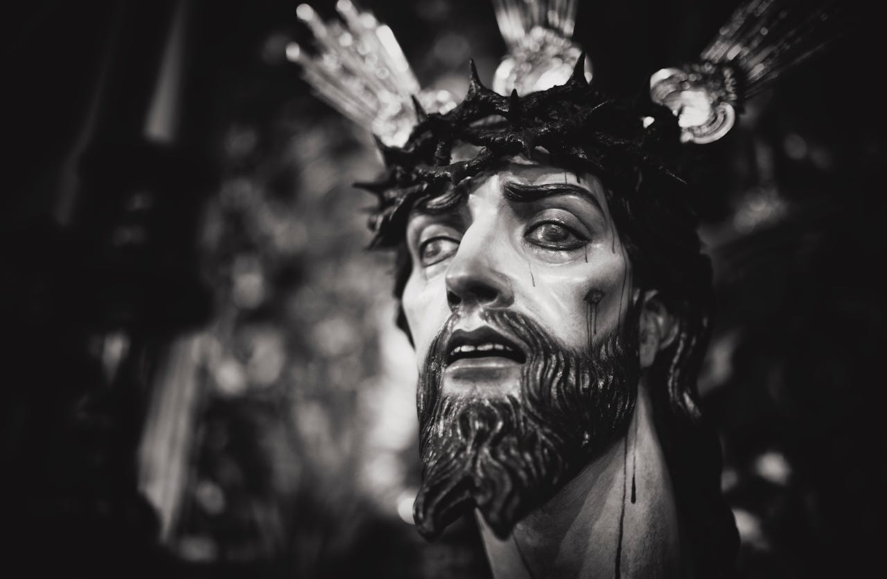 Close-up of a sacred religious statue in grayscale, conveying deep emotion.