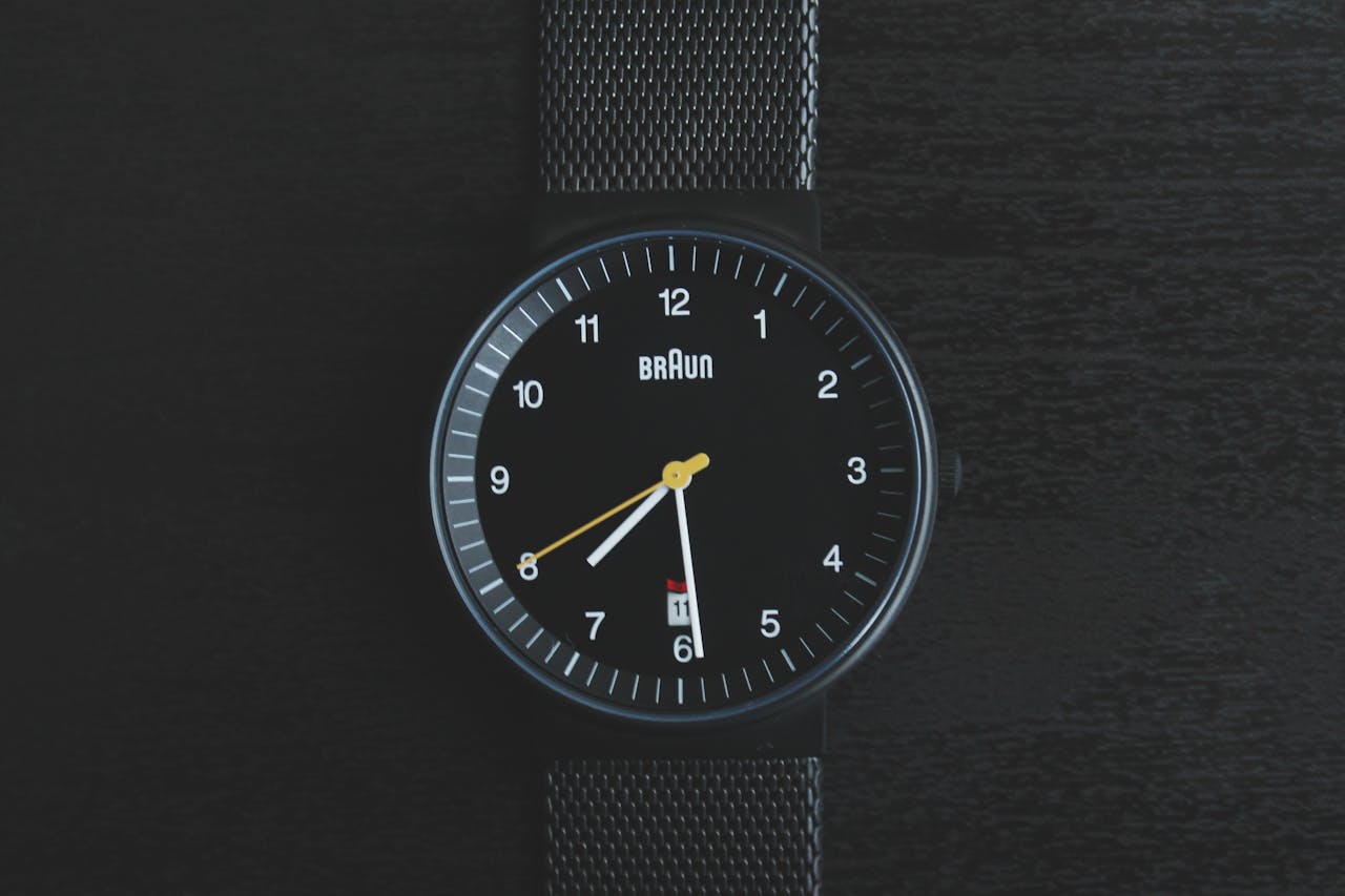 Elegant black wristwatch with a sleek design and precise timekeeping features.